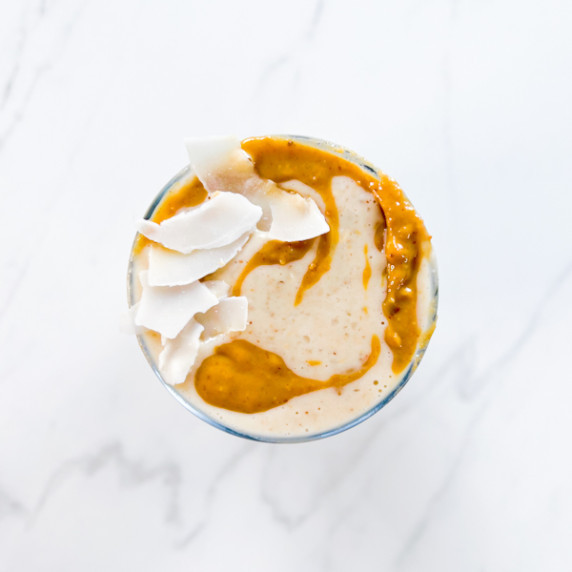 Peanut butter banana date smoothie with coconut on top.