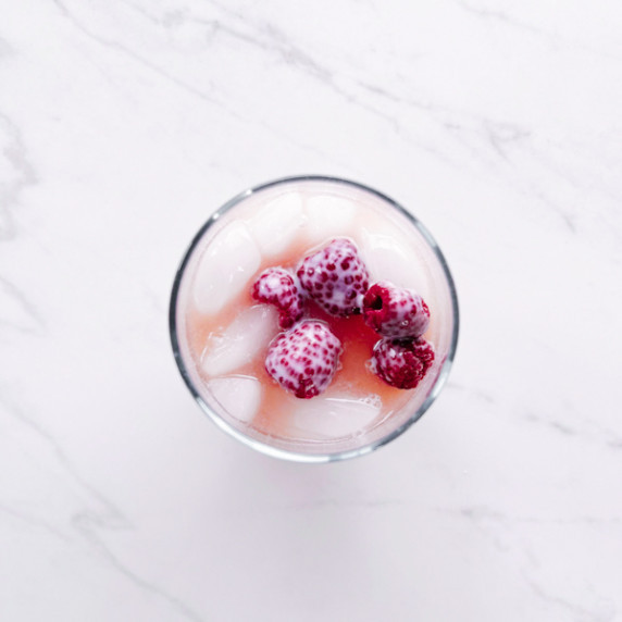Starbucks pink drink with raspberries as ice.