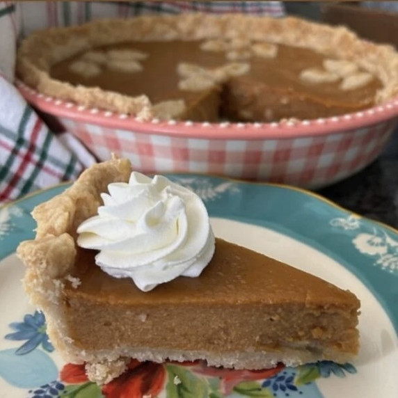 pumpkin pie slice with whipped cream on top