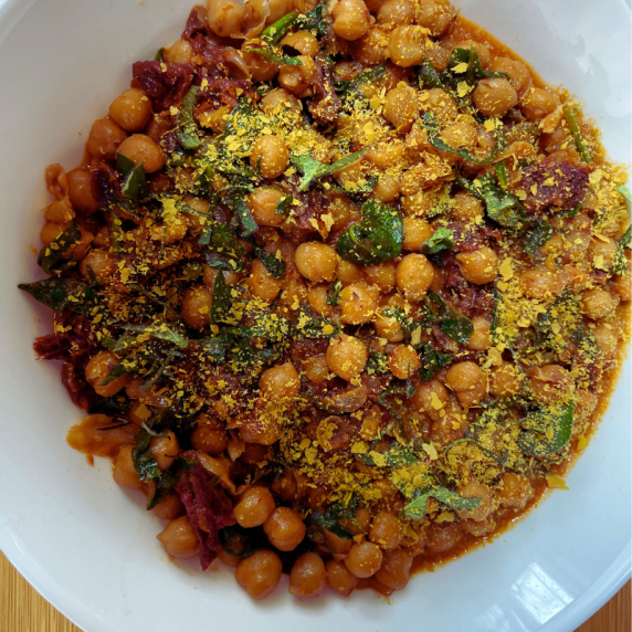 MARRY ME CHICKPEAS ARE VEGAN TOPPED WITH FRESH OREGANO AND NUTRITIONAL YEAST