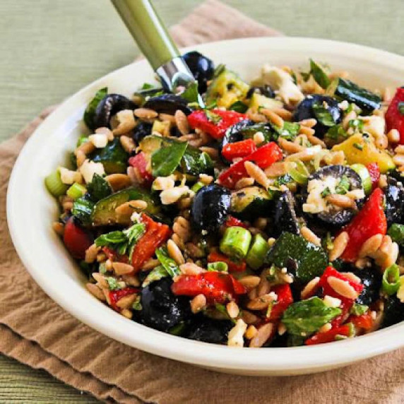 Grilled Vegetable Salad with Feta shown in serving bowl with spoon.