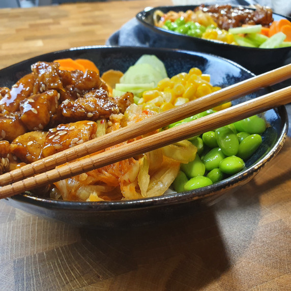 Poke Bowl with rice and chicken on countertop