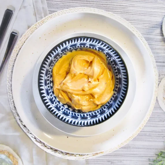 Homemade Porcini Mushroom Mayonnaise in a blue dish served on a neutral tablecloth
