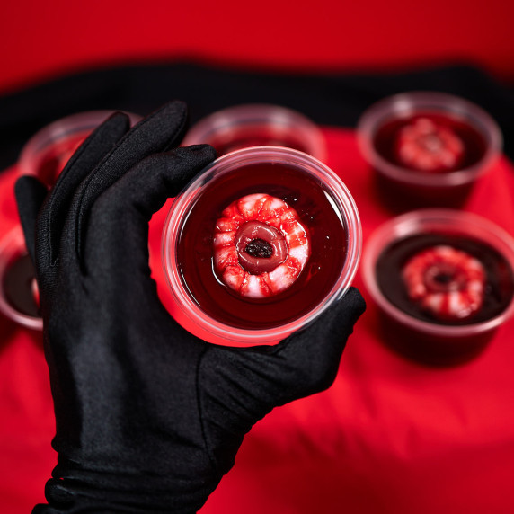 Red jello shot with floating lychee eyeball.