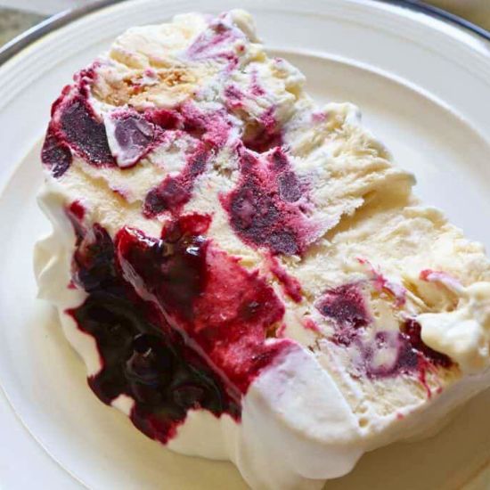 Thick, creamy frozen semifreddo with vibrant blueberry swirls and bright lemon cheesecake flavor.