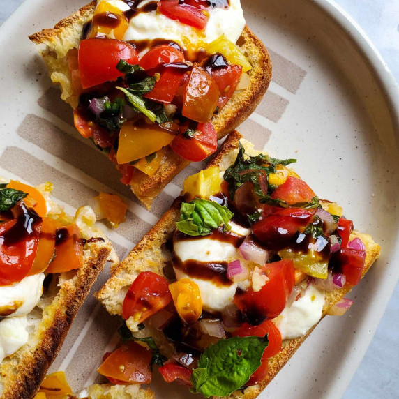 Toasted bread with fresh veggies, white & creamy burrata, and black balsamic.