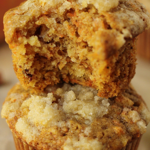 vegan carrot apple muffins stacked with bite taken out
