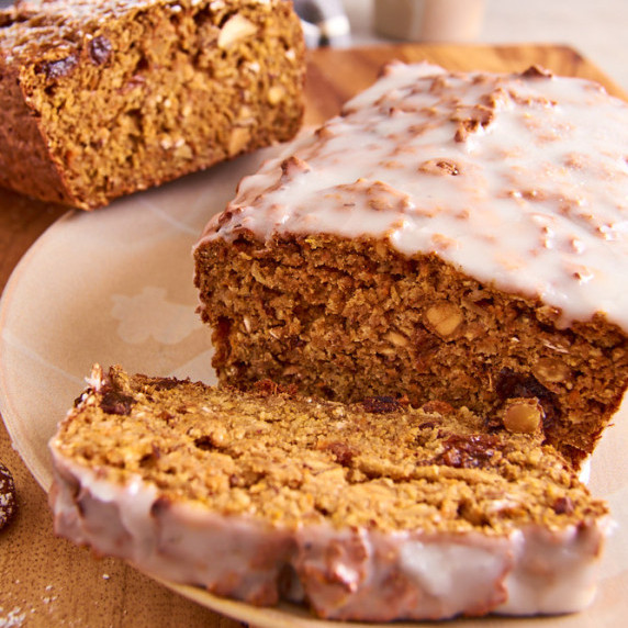 Carrot Cake Protein Banana Bread with a lemon glaze, a slice cut off in front