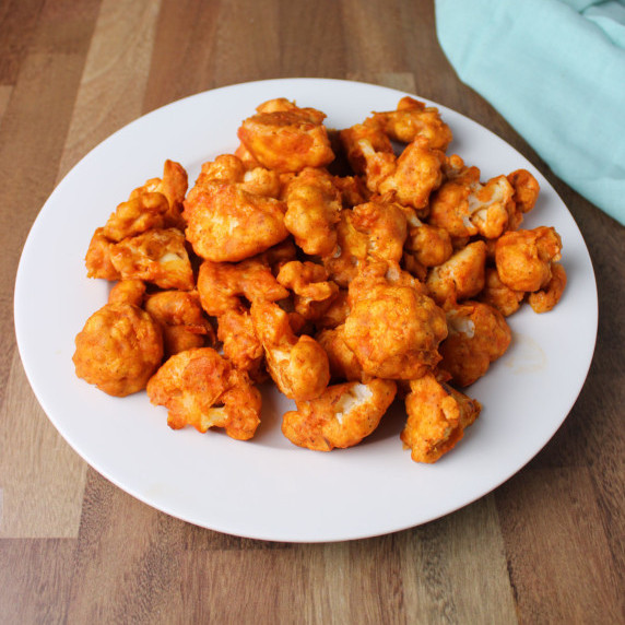 Plate of buffalo cauliflower bites on a table.