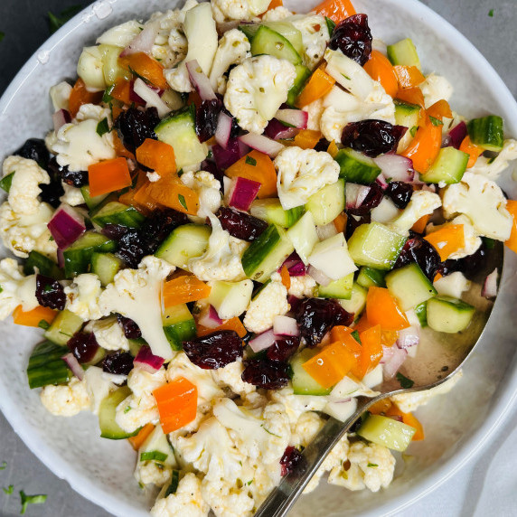 Chopped cauliflower, orange pepper, cucumber, red onion and dried cranberries in a vinaigrette.