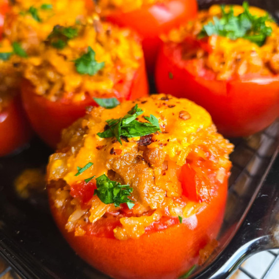 Plump red tomatoes stuffed with a cheesy filling and topped with Red Leicester cheese.
