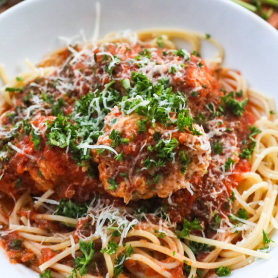 moist homemade chicken meatballs recipe in homemade marinara sauce with spaghetti