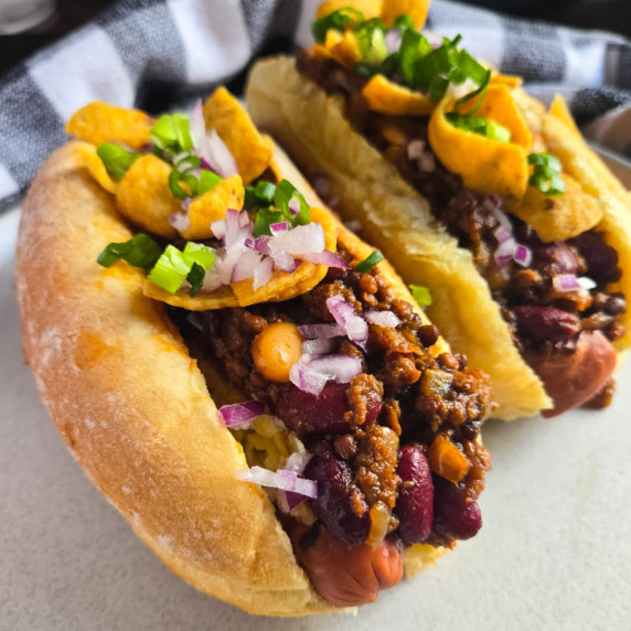 Chili dogs topped with red & green onions and crispy Fritos.