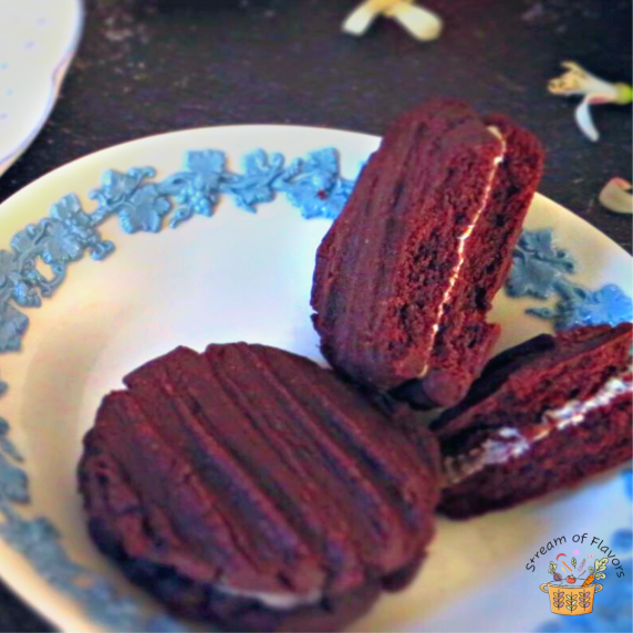Chocolate Cookies With Cream Filling on a blue and white plate