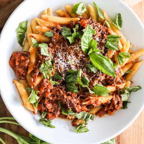 Homemade slow roasted chuck roast ragu pasta with fresh basil and parmesan cheese. 
