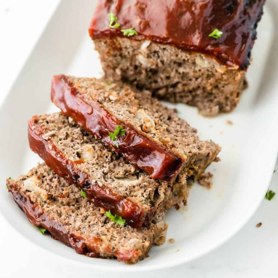 Sliced meatloaf from above on a platter.