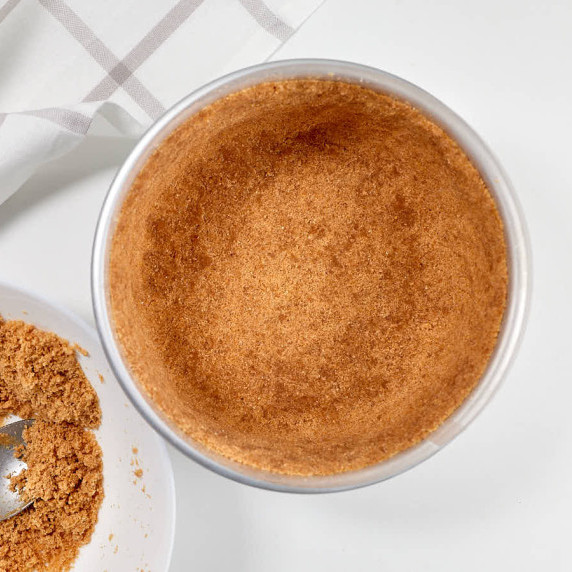 Coconut flour crust in cheesecake pan.