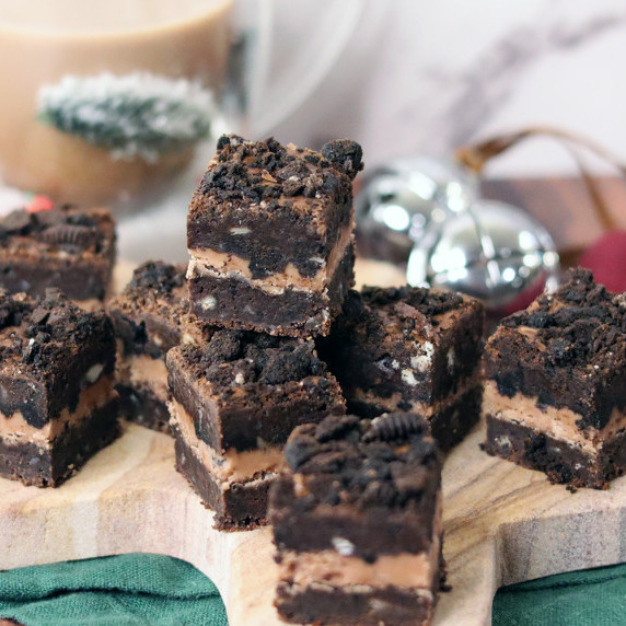 Three Triple Chocolate Cookies and Cream Brownies arranged on a Christmas plate.