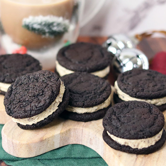 Cookies and Cream Cookie Dough Brownie Sandwiches on a gingerbread man serving board.