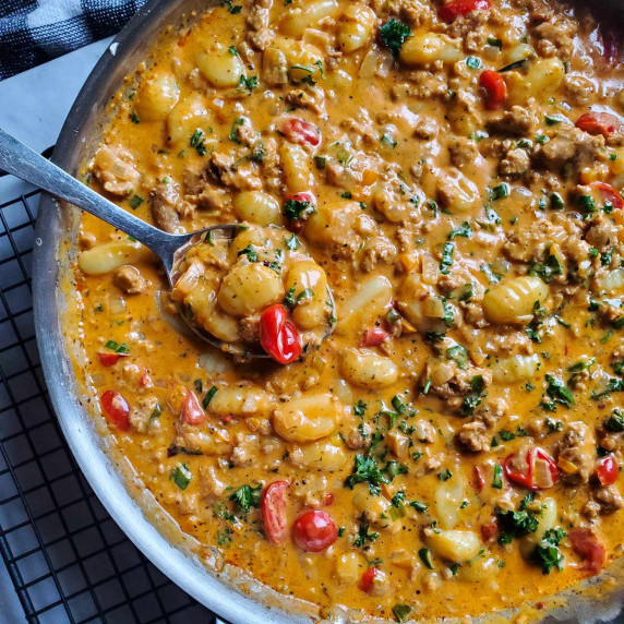 A skillet full of creamy, colourful gnocchi