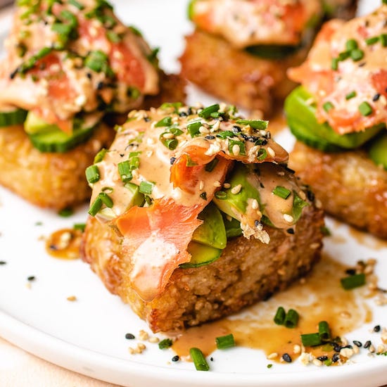 Crispy rice sushi sliced smoked salmon, avocado, sesame seeds, chives and bang bang sauce