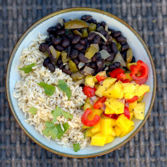 bowl of rice, beans, salsa on a wicker chair