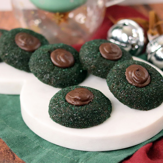 Dark chocolate mint thumbprints arranged on a holiday plate