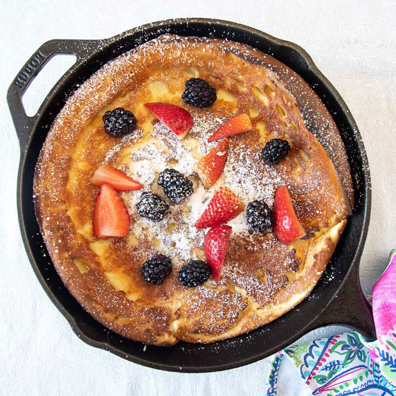 Dutch Baby pancake in frying pan with berries 