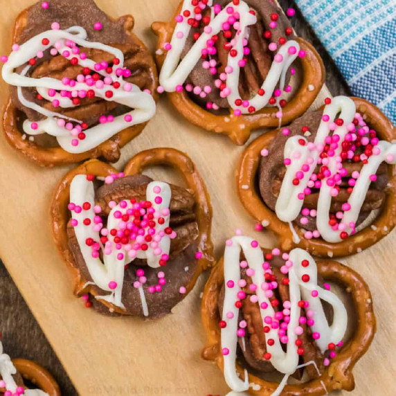 Close up of Rolo pretzel chocolates decorated with sprinkles.