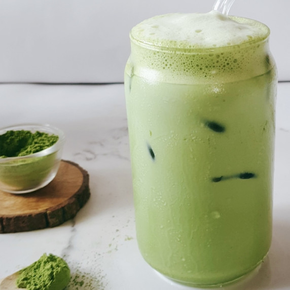 Starbucks Copycat Matcha Latte Recipe in a tall glass with ice cubes.
