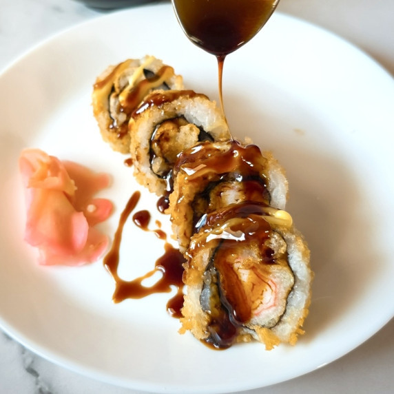 Unagi sauce or Eel sauce drizzled over sushi rolls.
