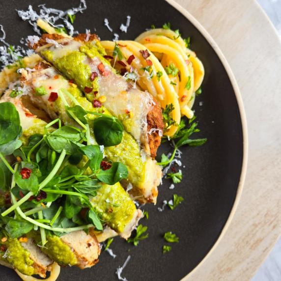 Crispy, golden patties with melty cheese and vibrant green pesto on pasta