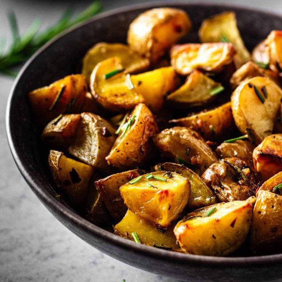Garlic rosemary roasted potatoes in a dark grey bowl