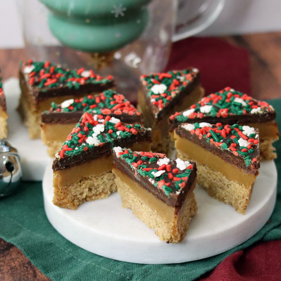 White chocolate and dark chocolate variations of Graham Cracker Millionaire Bars on a holiday plate