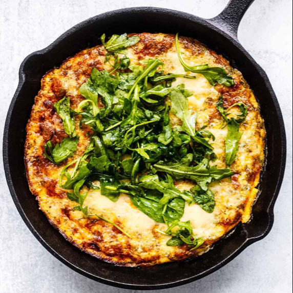 Overhead view of ham and cheese frittata in a cast iron skillet.