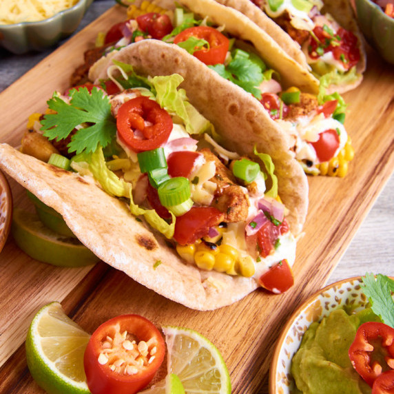 Soft Tacos with chicken, cashews, charred sweetcorn, zingy salsa, sour cream-yoghurt-lime drizzle 