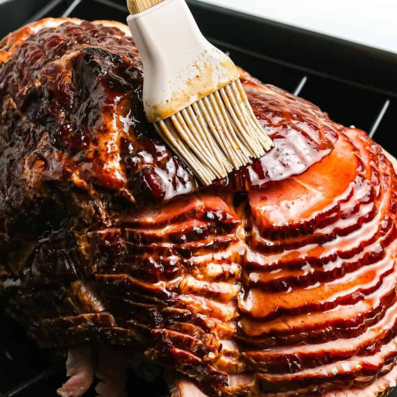 Silicone brush glazing a ham.