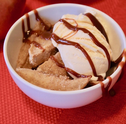 Air Fried apples in a white bowl on a red tablecloth.  