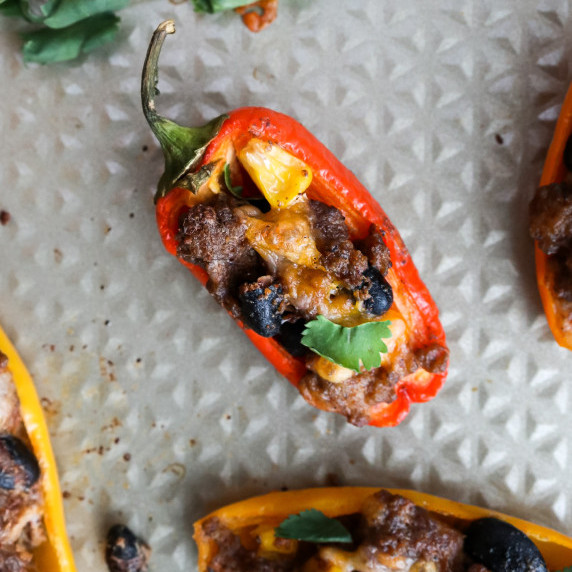 Close up photo of a mini pepper stuffed with beans, corn, beef, and cheese