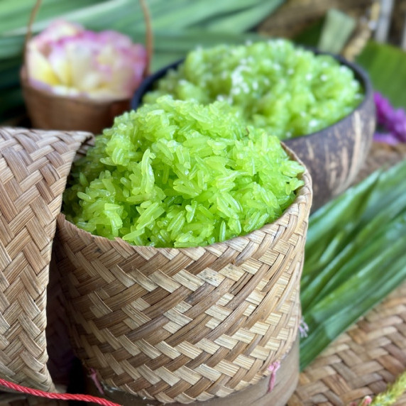 Pandan sticky rice served in a traditional handwoven bambo basket.