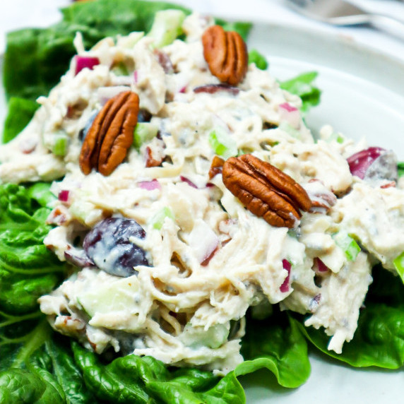 A dish of California chicken salad in a bed of lettuce