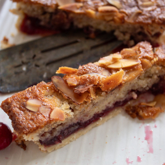 cranberry almond bars sliced on serving platter. 