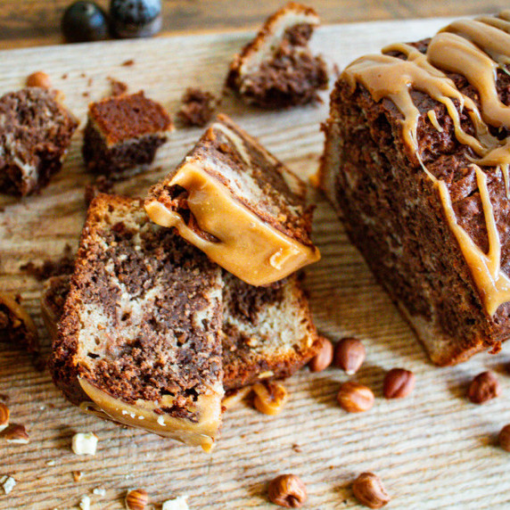 photo of banana bread sliced on wooden cutting board.