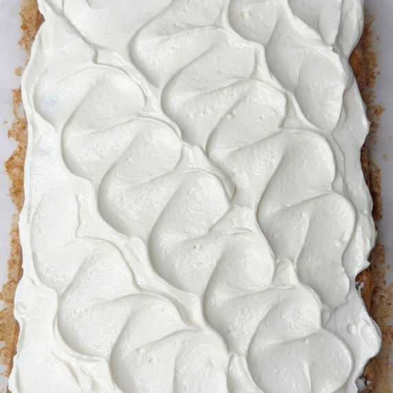 Healthy cream cheese frosting on apple caramel cake. 