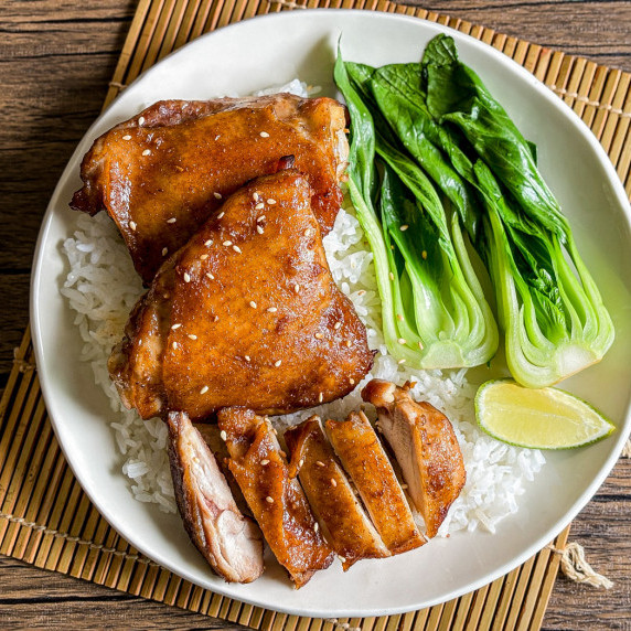 Top-view of hoisin chicken with blanched choy sum and jasmine rice.