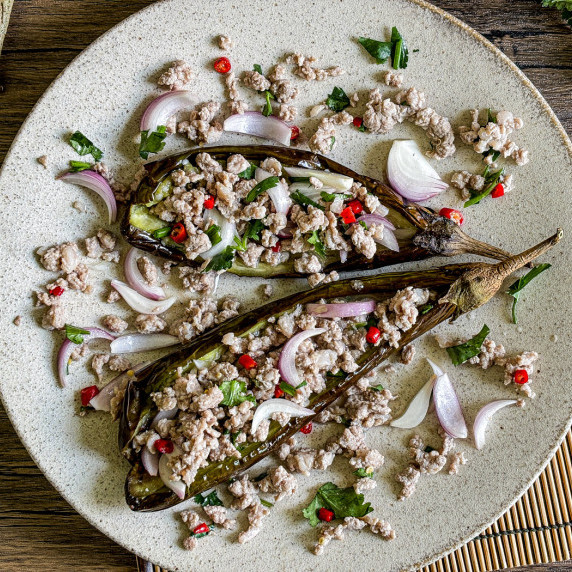 Thai eggplant salad topped with ground pork, shallots, and fresh herbs.