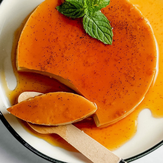 vanilla flan on a plate with a spoon 