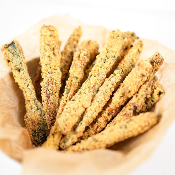 Basket full of golden zucchini fries.