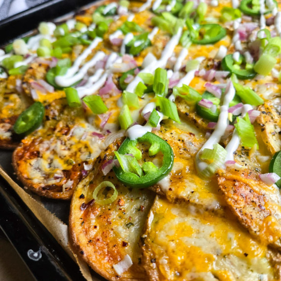 Crispy golden potatoes topped with marble cheddar, white cream, and red & green onions.