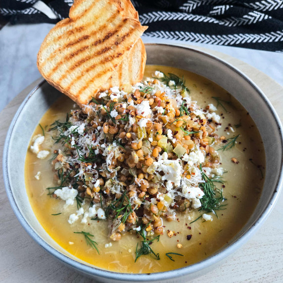 Golden grilled toast, broth, and white feta, green dill, and heaps of lentils.